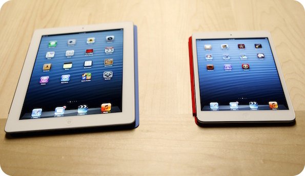 The new iPad mini is shown next to a full sized model at an Apple event in San Jose